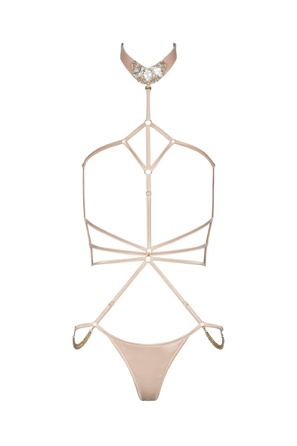 Open strappy Calypso playsuit  in Oyster Blush with cage-style straps and provocative cut-outs, evoking a bondage-inspired aesthetic