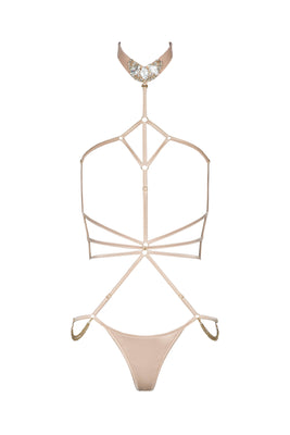 Open strappy Calypso playsuit  in Oyster Blush with cage-style straps and provocative cut-outs, evoking a bondage-inspired aesthetic
