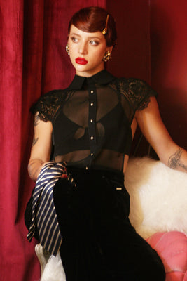 Serafina black sheer silk chiffon top layered over a black bra for an underwear-as-outerwear look