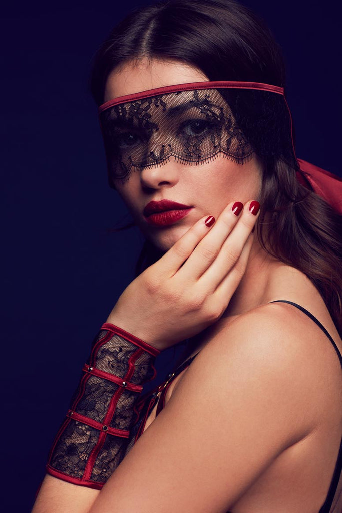 Luxury lace cuffs and blindfold with red satin trim, part of Odette designer seductive lingerie collection by Tatu Couture